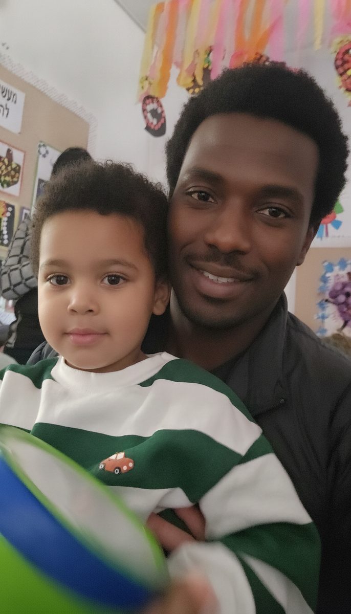 A dad and his boy in a selfie at kindergarten
